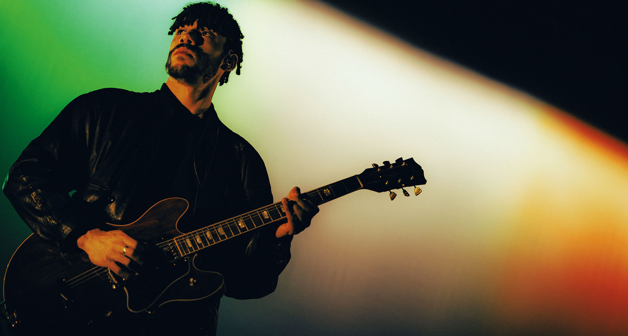 Josh Jenkinson of Inhaler plays his 1976 ES-335 live onstage, silhouetted against the stage lights.