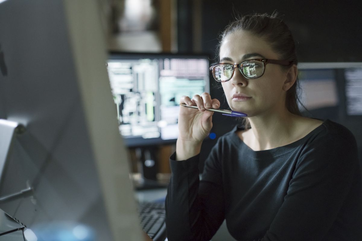 A cyber security researcher at their desk