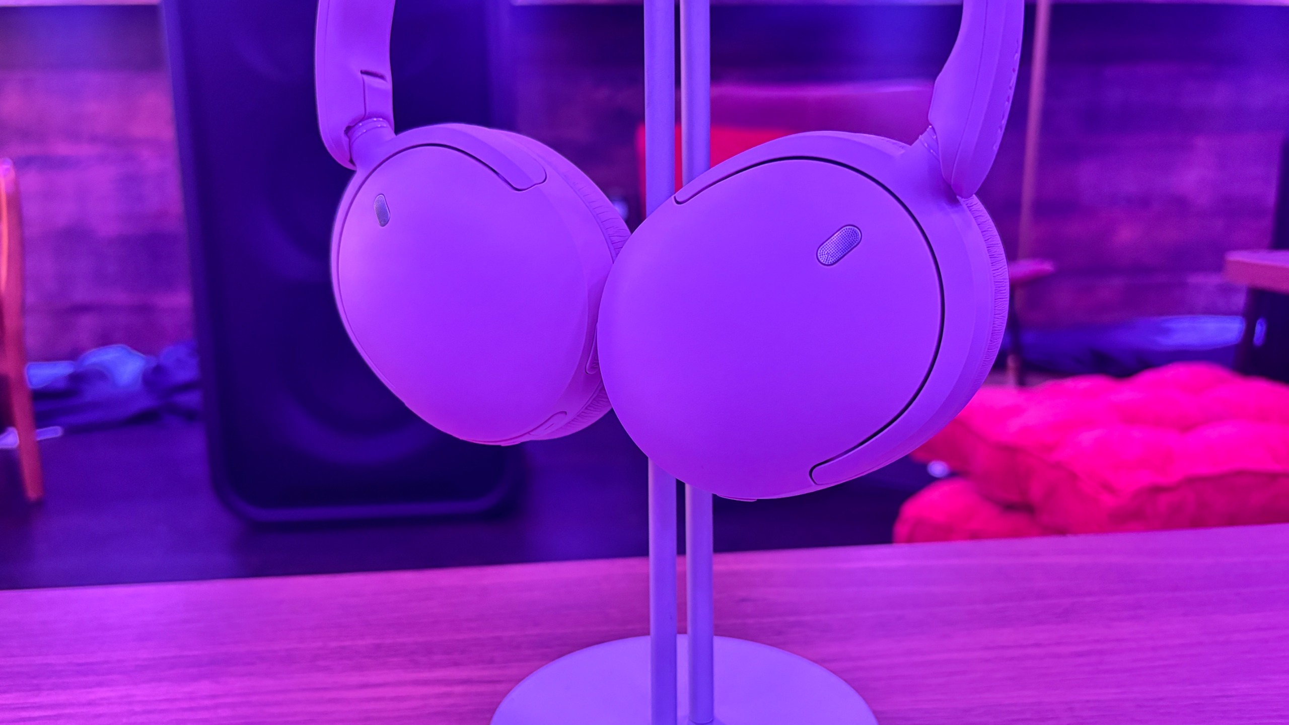 Sony WH-CH730N wireless headphones in lavender on a wooden table