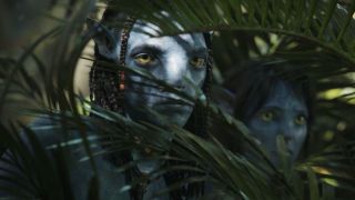 Jake Sully peering through plants in Avatar: The Way of Water