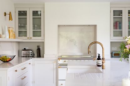 White kitchen with brass hardware