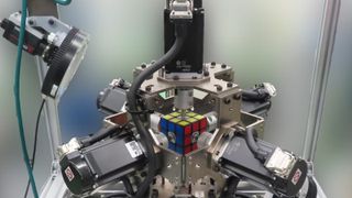A photo of the full robot holding the rubik's cube