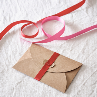 Brown envelope with red ribbon