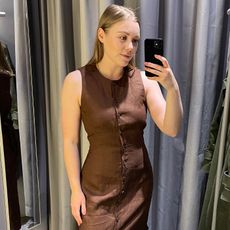 Woman in dressing roomwears brown linen dress