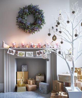 Alternative Christmas tree ideas with a white twig tree with no leaves and pinecone decorations