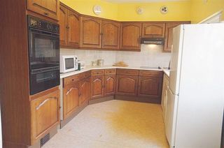 Before shot of a kitchen with dark wood units