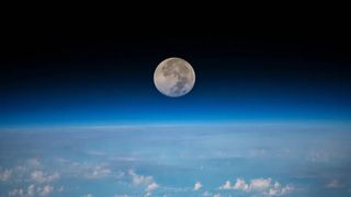 A close up of the moon with the Earth below
