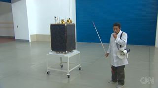 In this still from a CNN broadcast, a North Korean official briefs reporters on the Kawngmyongsong-1 ("Bright Star 1") satellite, which is set to launch atop the country's Unha-3 ("Galaxy-3") rocket to launch in April 2012.