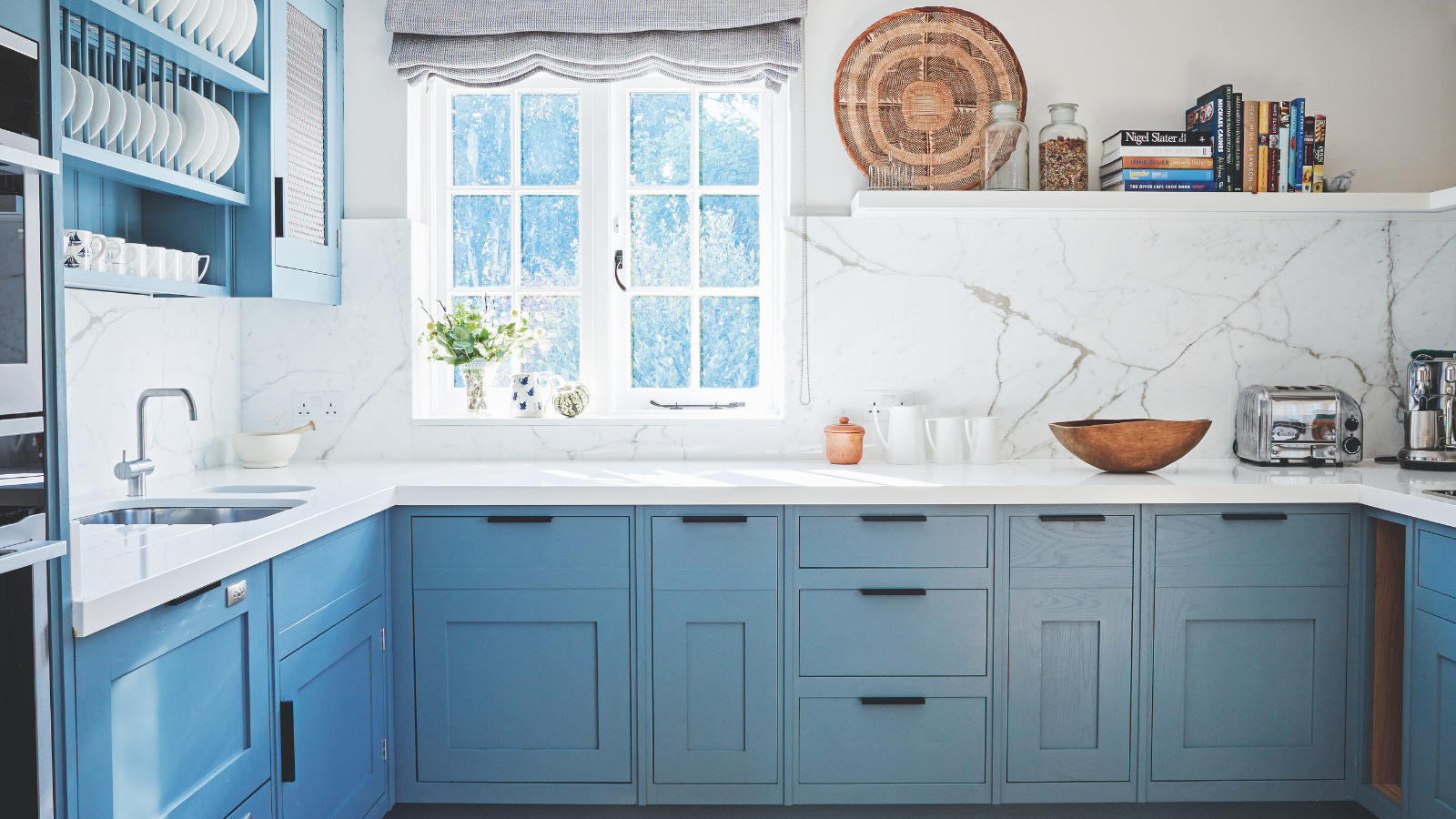 a power blue kitchen with a window