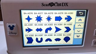 A photo of the ScanNCut SDX2200D's LCD screen with quilt patterns