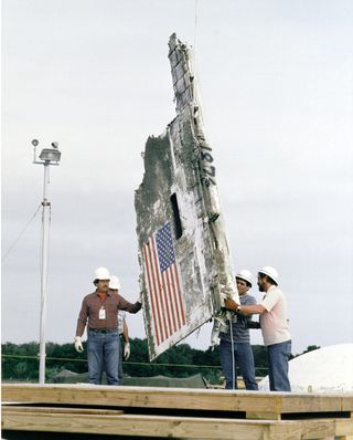 Workers lower STS-51L Challenger wreckage remains and boxes of debris into abandoned Minuteman Missile Silos at Complex 31 on Cape Canaveral Air Force Station.