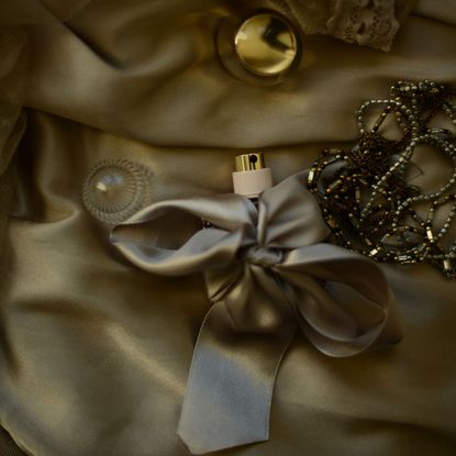 A festive perfume wrapped in a gold bow