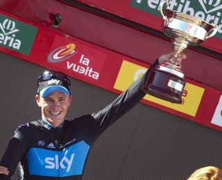 Stage winner Chris Froome (Sky) holds his trophy aloft.