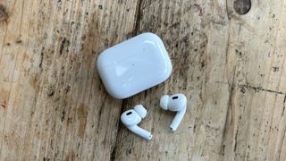 Apple AirPod 2 headphones next to case
