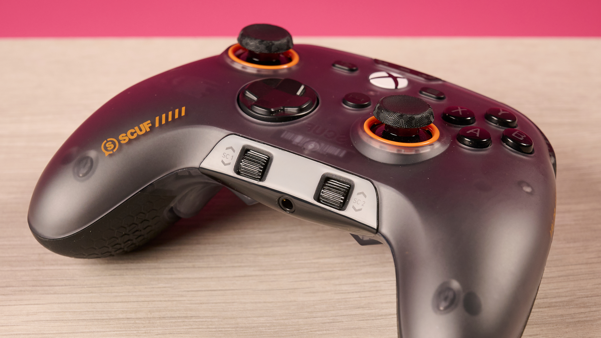 A closeup of the Scuf Valor Wired with TMR, showing its dual volume dials and headset port.