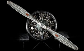 Rimowa aircraft details. The motor and propeller are front and center. The background is black.