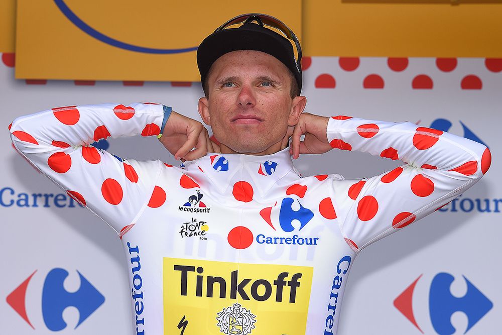 Rafal Majka pulls on the polka dot jersey after stage 19