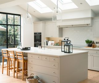 large neutral coloured fitted kitchen in room with skylight