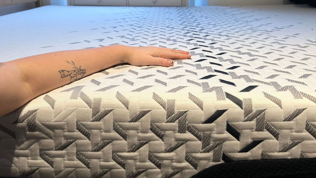 Arm and hand of a tester for Tom's Guide resting on the Nectar Luxe mattress