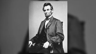 Black and white portrait of Abraham Lincoln seated.