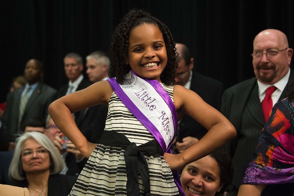 Obama embraces adorable Little Miss Flint. 