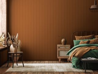 bedroom with terracotta panelled walls and olive green bedding