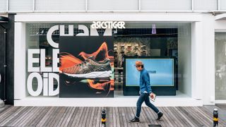 ASICS Tiger rebrand with man walking past shop window
