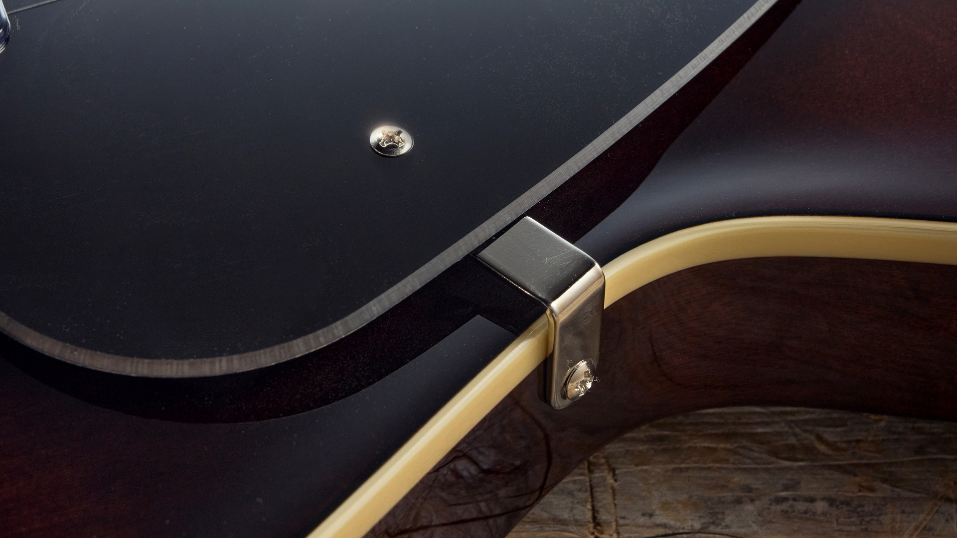 Close up of the pickguard mounting screw on the Gretsch Electromatic Jet Baritone