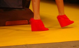 Red wedge shoes with a bow at the heel