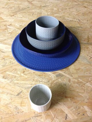 Ceramic plates, bowls, and cups in various shades of blue.