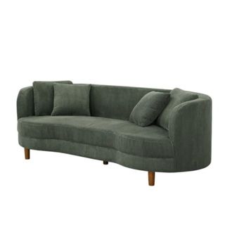 A dark green curved couch with two throw pillows and dark brown wooden legs