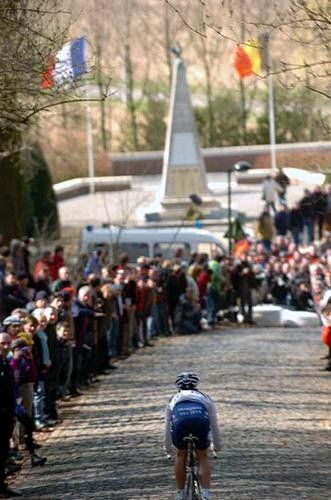 An FDJ rider takes the Kemmelberg descent alone