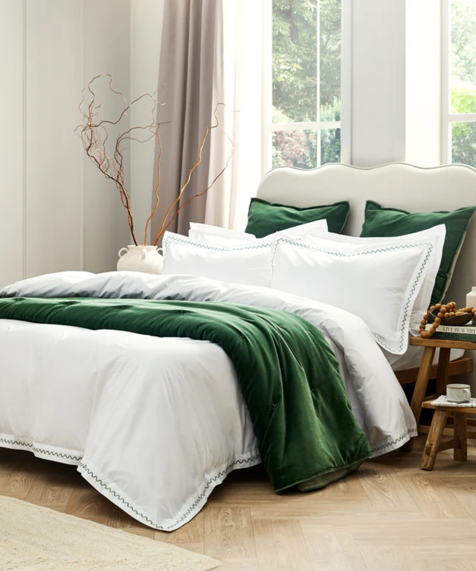 Christy bedscape featuring squiggle-border cotton sheets and green pillowcases