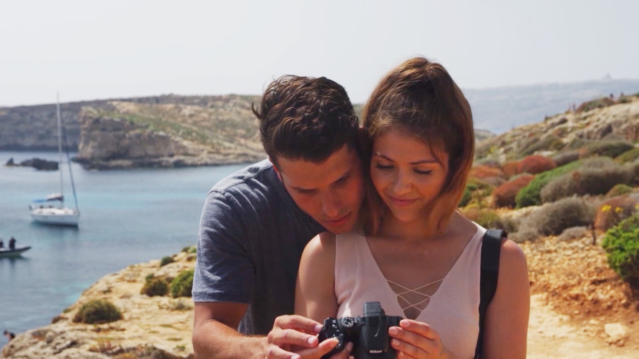 Ashley Brinkman and Cody Calafiore look at a picture in The Maltese Holiday.