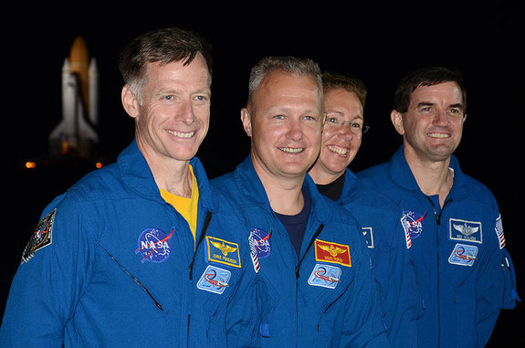 Shuttle Atlantis&#039; final crew, commander Chris Ferguson, pilot Doug Hurley and mission specialists Sandy Magnus and Rex Walheim, stand in front of the orbiter as it rolls out to the launch pad one last time.