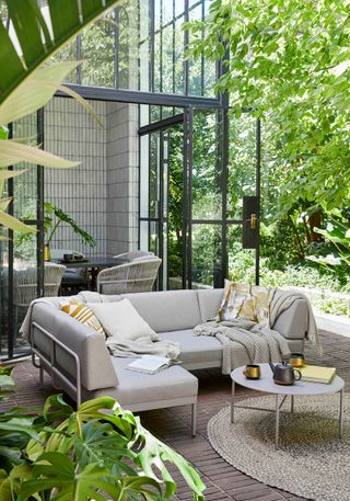 leafy patio scene with outdoor furniture from John Lewis