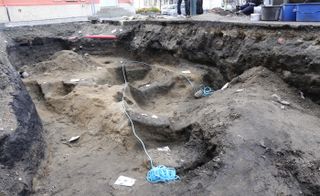 Archaeologists discovered the possible remains of a person buried in a boat in a market square in Trondheim, Norway.