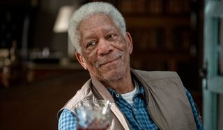 Morgan Freeman smiles while enjoying some wine in The Hitman's Wife's Bodyguard.