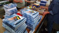 Workers put together copies of Microsoft's Windows 98 at the packaging line.