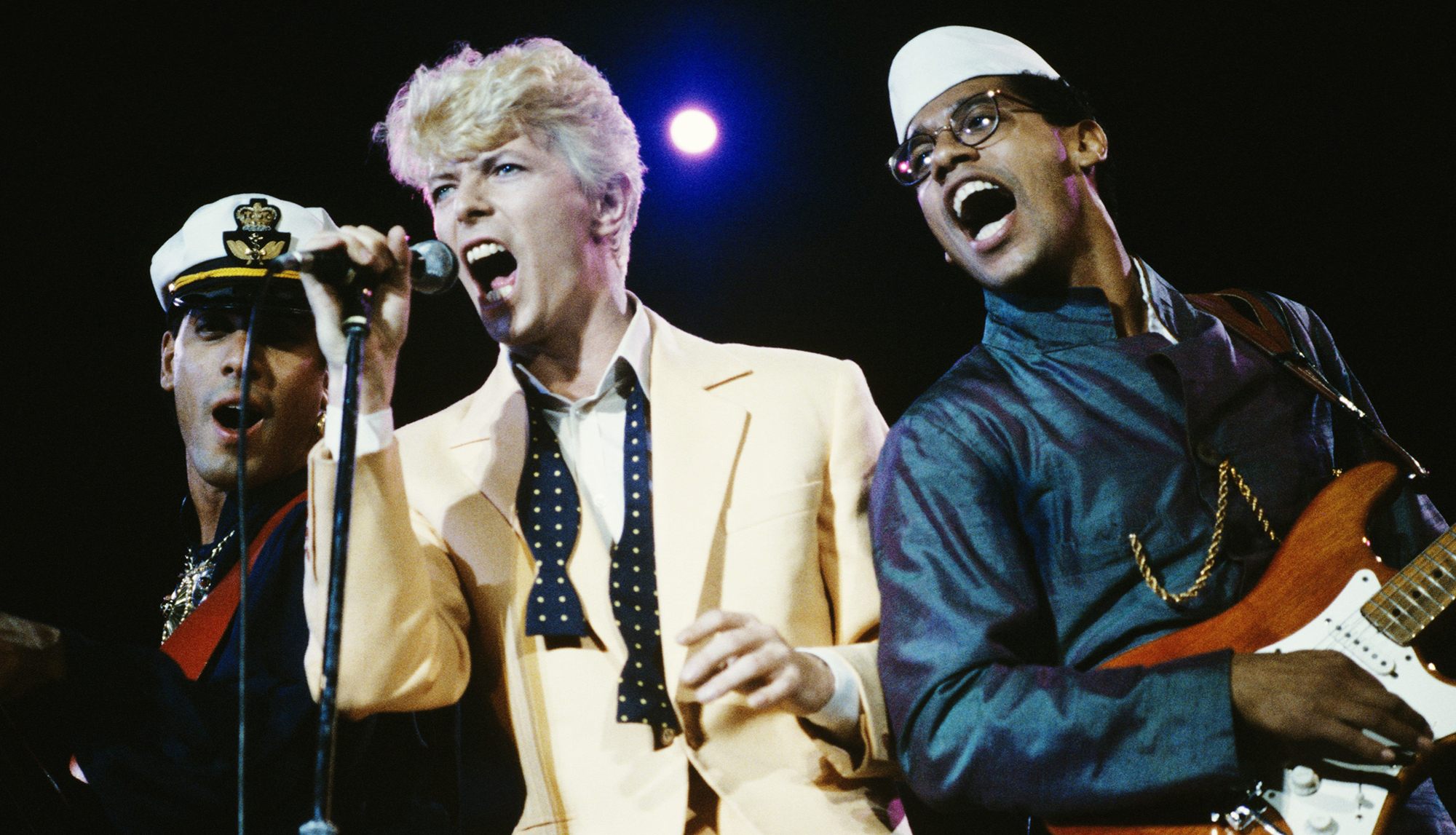 British singer-songwriter David Bowie (centre) performing with bassist Carmine Rojas (left) and Carlos Alomar at BC Place in Vancouver, during Bowie's Serious Moonlight tour, Canada, 9th August 1983. 