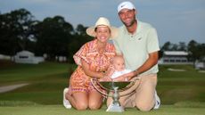 Scottie Scheffler with wife Meredith and baby son Bennett who is sitting in the FedExCup itself