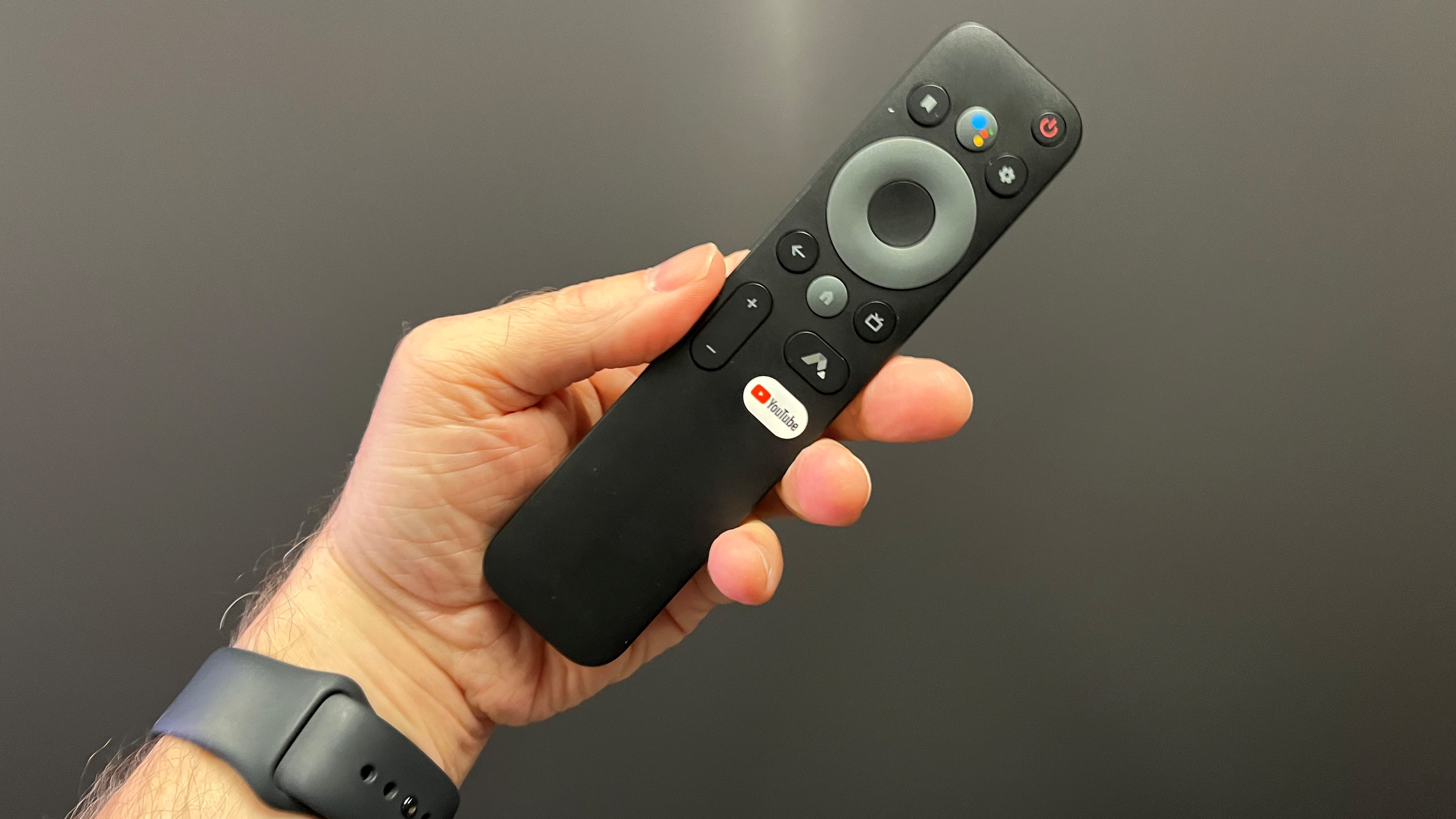 Hand holding Formovie Theater remote control