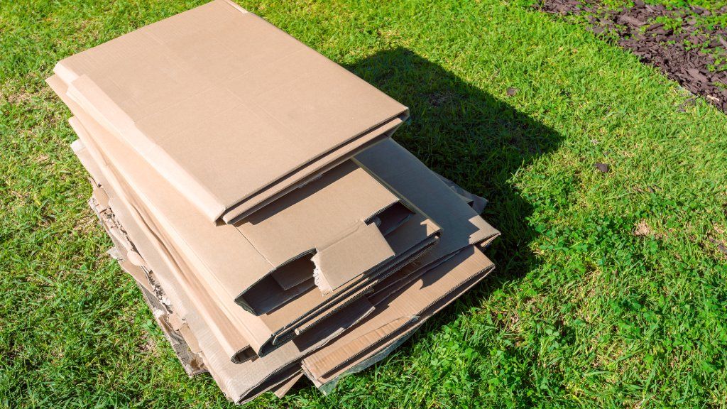 A stack of cardboard on a lawn