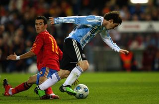 Spain's Sergio Busquets attempts to stop Barcelona team-mate Lionel Messi in a friendly with Argentina in 2009.