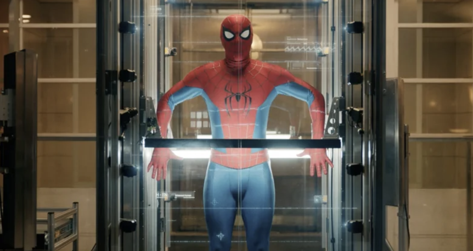 an image from the new spiderman brand new day trailer showing spiderman / peter parker being scanned in a box