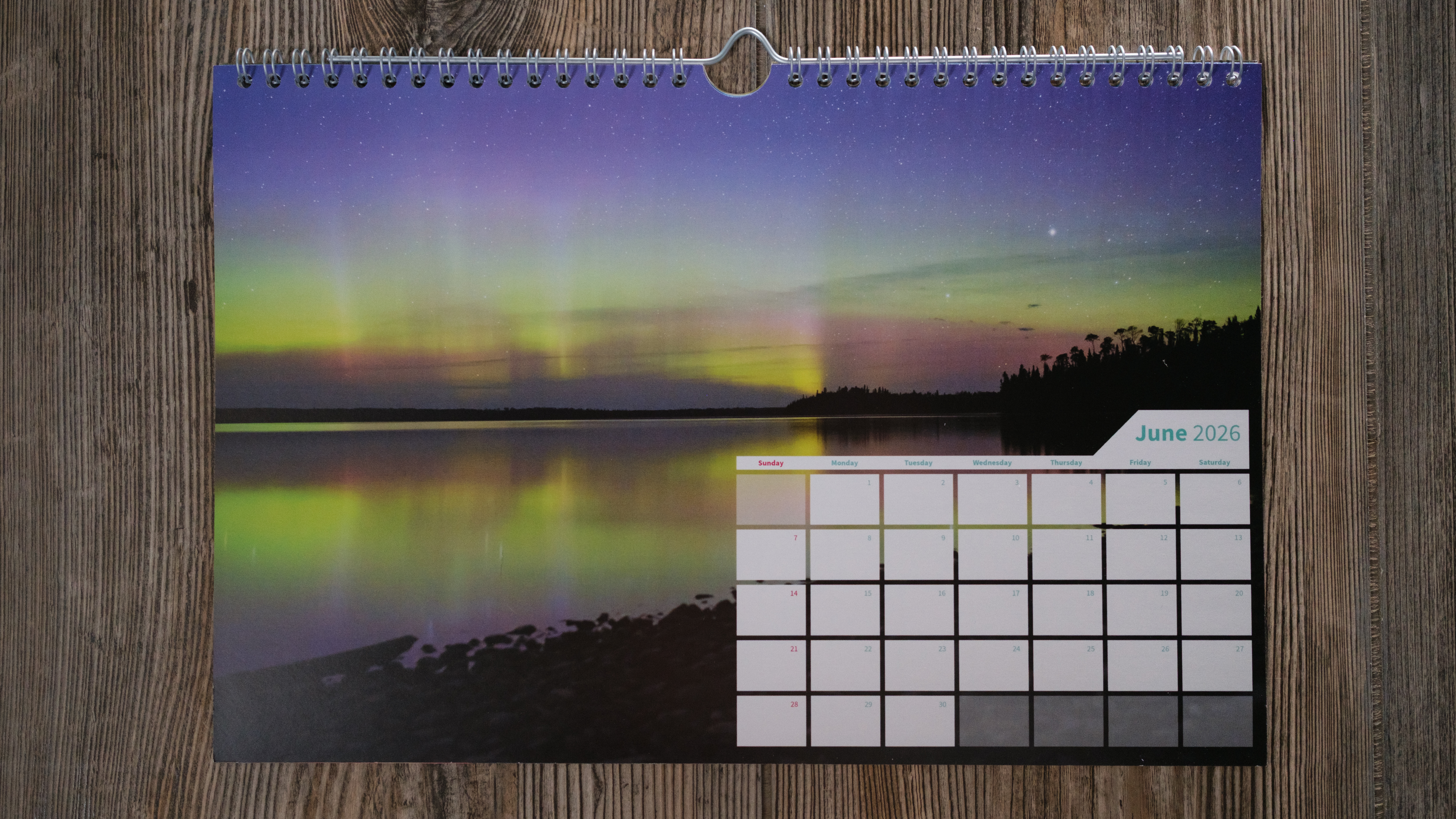 A wall calendar from Saal on a wood background