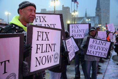 Demonstrators demand action over the water crisis in Flint.