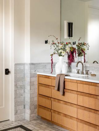a vanity in a marble tiled bathroom