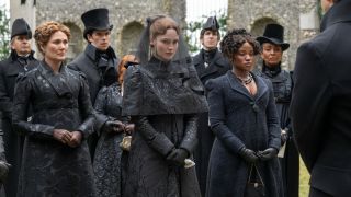 From left to right: Ruth Gemmell, Luke Newton, Hannah Dodd, Masali Baduza and Adjoa Andoh all wearing black during a funeral scene in Bridgerton. 