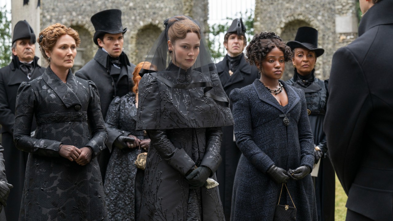 From left to right: Ruth Gemmell, Luke Newton, Hannah Dodd, Masali Baduza and Adjoa Andoh all wearing black during a funeral scene in Bridgerton. 